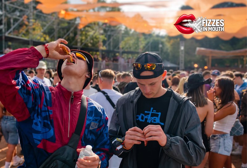 Tipping a stick straight onto the tongue at a festival, with the Fizzes in Mouth badge